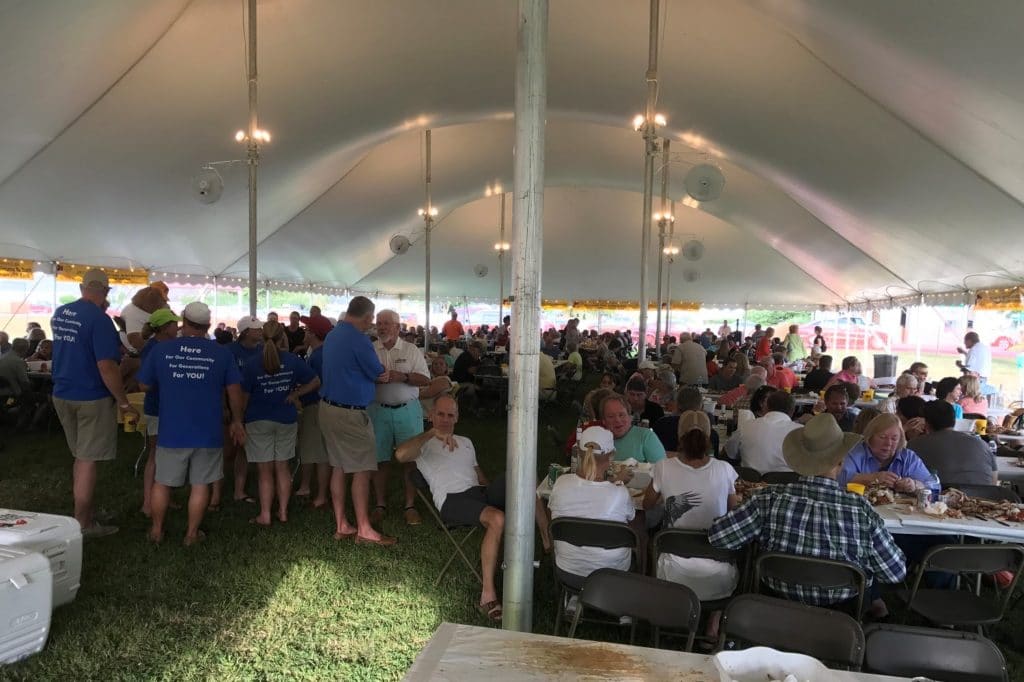 People eating under the tent at the Irvington Crab Festival