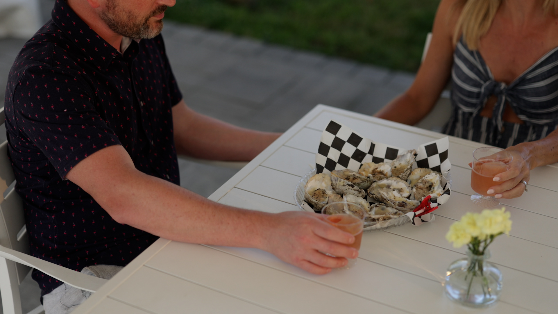 Couple dining on a basket of raw oysters